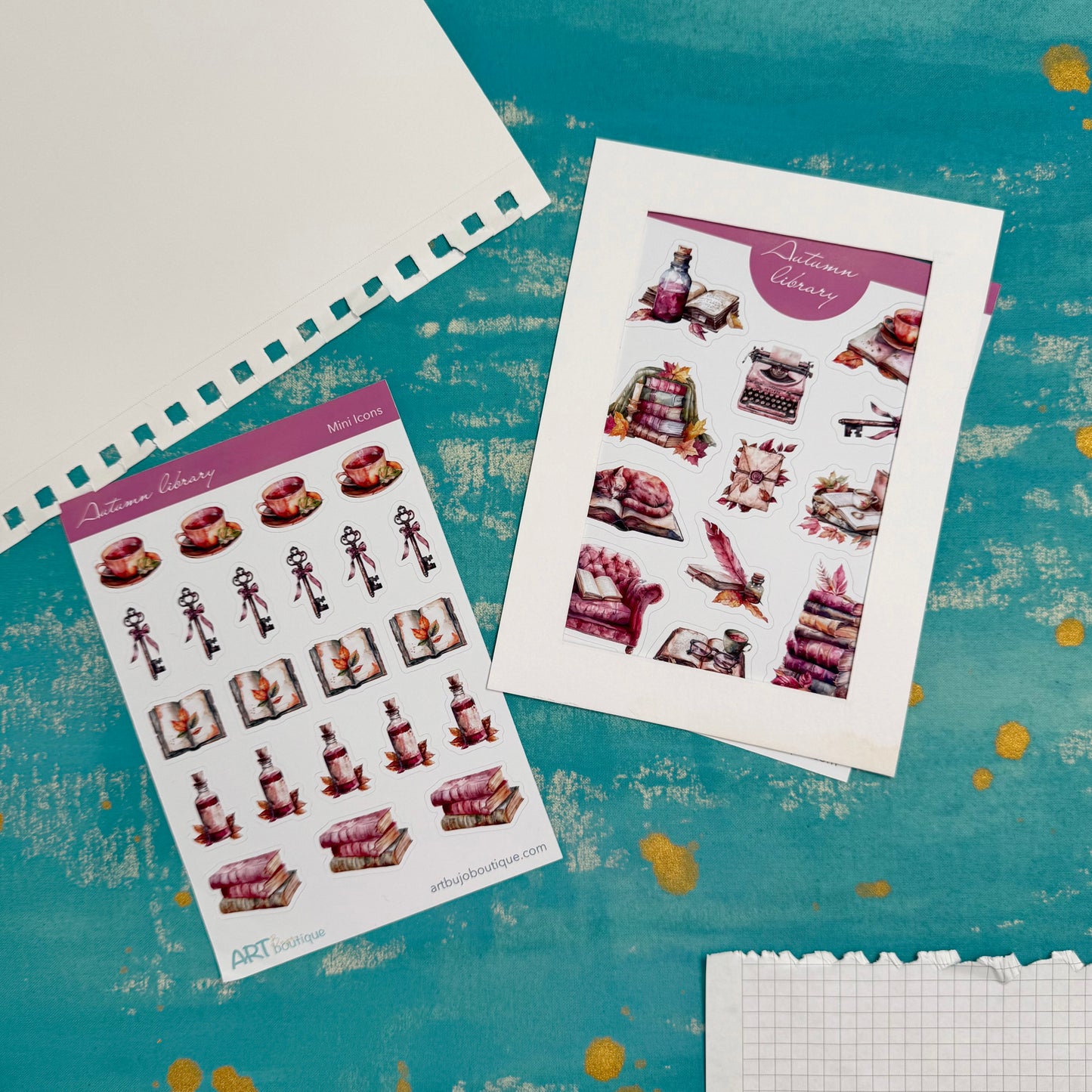 Two sheets of decorative stickers featuring cakes and bottles on a textured blue surface.