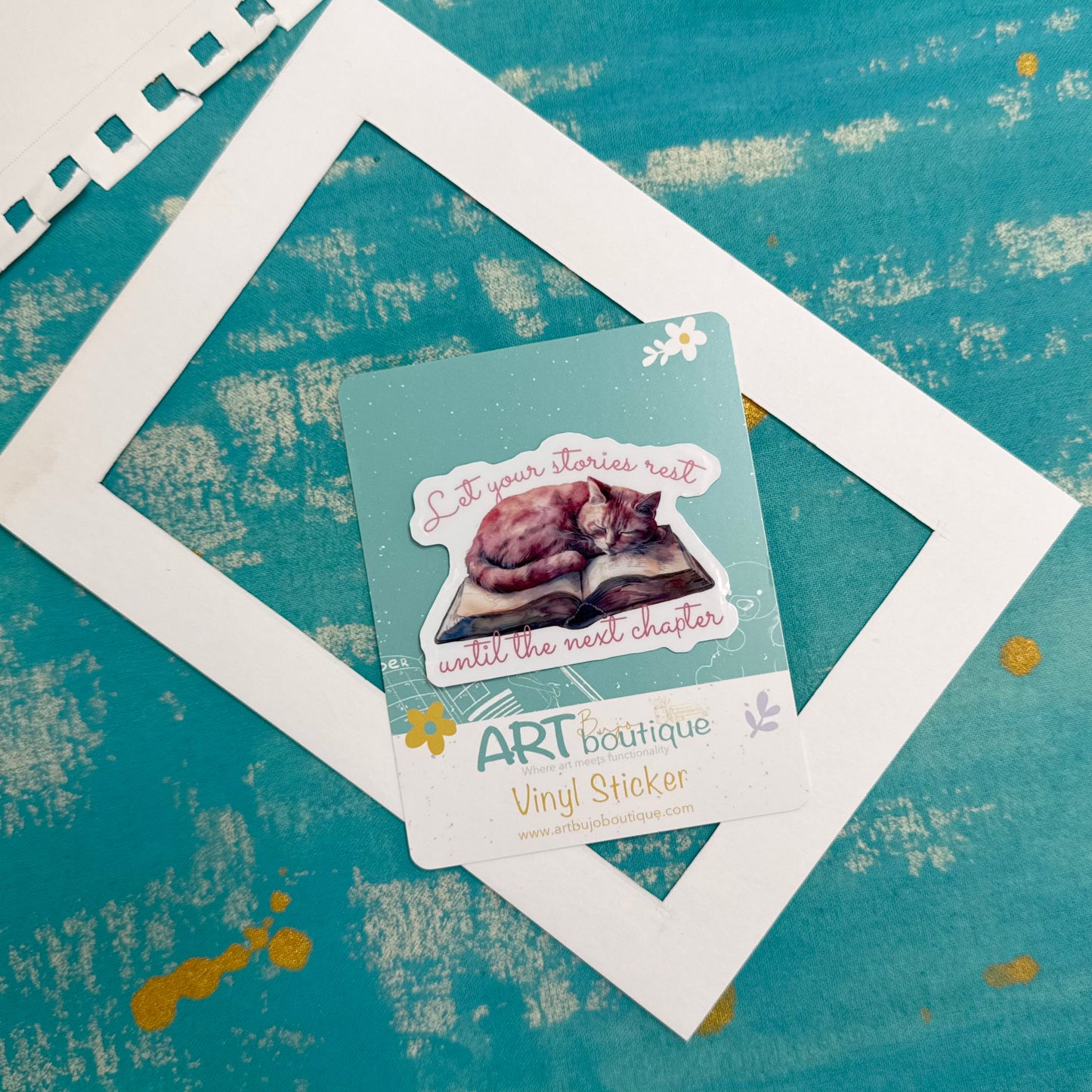 Vinyl sticker with text and illustration on a textured teal background