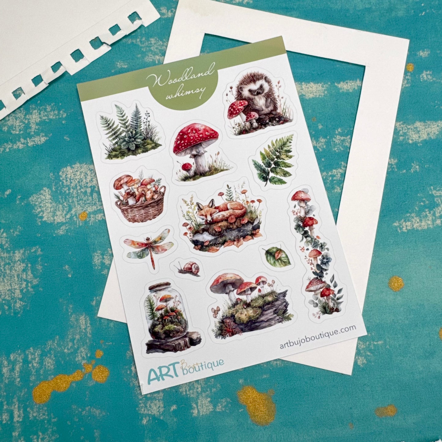 Sheet of nature-themed stickers with mushrooms, plants, and animals on a textured blue background.