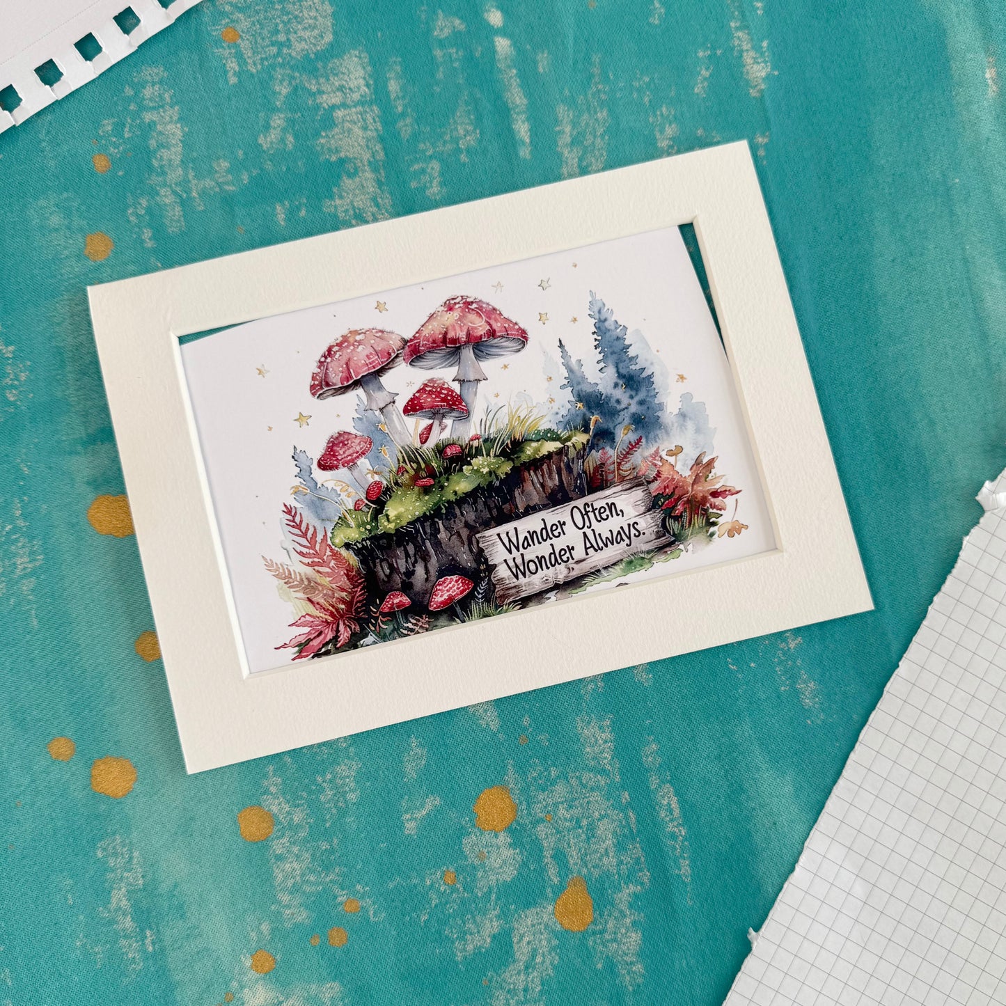Framed artwork with mushrooms and text on a textured teal surface