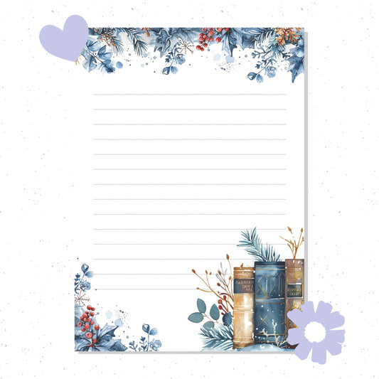 Decorative notepad with floral designs and stationery items on a white background