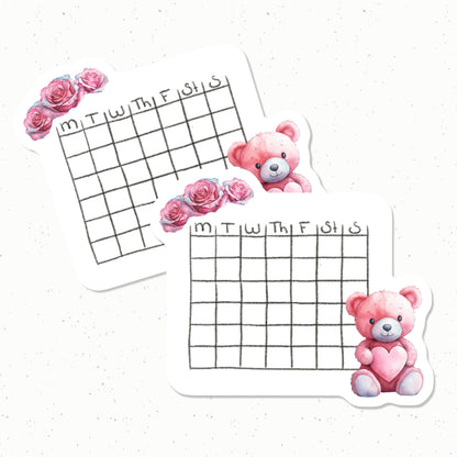 Two small calendars with pink teddy bears and flowers on a white background