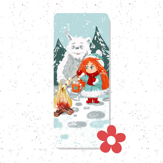 A vertical rectangular print or card featuring a winter illustration of a girl with bright orange hair standing in snow beside a campfire, with a large white dog and pine trees in the background. The print is centered on a white speckled backdrop with a red flower graphic near the bottom right.
