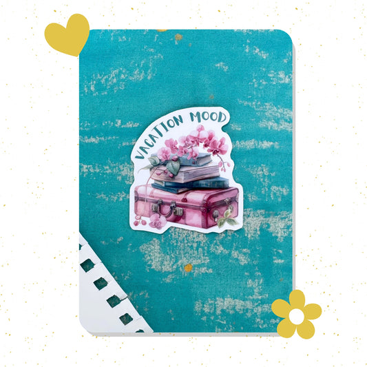 Sticker with a pink suitcase and flowers on a textured blue card