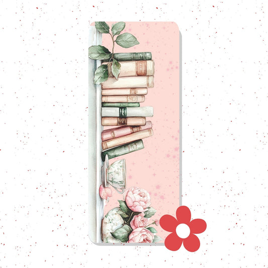 A vertical rectangular card or print with a pale pink background, decorated with a stack of vintage books, green leaves, pink flowers, and a red flower icon in the lower right. The item is centered on a white speckled background.