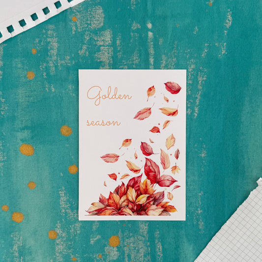 Card with autumn leaves design and 'Golden season' text on a textured teal background.